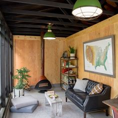 a living room filled with furniture and a wood burning stove in the middle of it