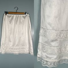 Dainty 80s white lace slip skirt! This skirt has the prettiest lace trim on the bottom & is quite see through.  Size Small - Large Brand - Patricia Era - 80s Excellent Vintage Condition (FLAW - one tiny spot at the wait of the skirt - see last photo) Made in Canada Measurements LAYING FLAT Waist - 12.5" - 20" (Stretchy waistband) Hips - 23"  Length - 25" Please let me know if you have any questions! Fitted Summer Skirt With Delicate Lace, Summer Fitted Skirt With Delicate Lace, Fitted Delicate Lace Skirt For Summer, White Delicate Lace Skirt For Summer, Vintage Lace Trim Bottoms For Summer, Vintage Bottoms With Lace Trim For Summer, Vintage Bottoms For Summer Wedding, Vintage White Lace Bottoms, White Vintage Lace Bottoms