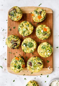 several muffins with different toppings on a cutting board