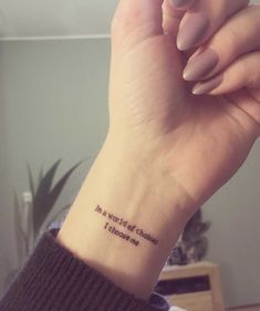 a woman's wrist with a small tattoo saying, in the words of someone else