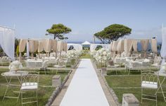 an outdoor wedding setup with chairs and flowers