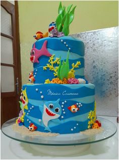 a three tiered cake decorated with sea animals