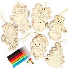 wooden cutouts with markers and pencils to make christmas decorations, including santa claus