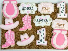 decorated cookies in a box for first birthday