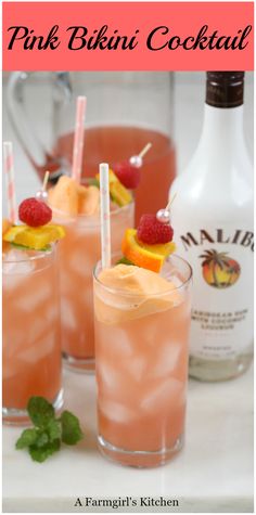 three glasses filled with pink drink and garnished with raspberries