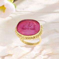 Ross-Simons - Italian Pink Venetian Glass Cameo-Style Ring Over Sterling. Size 5. Revel in the beautiful craftsmanship of this pink Venetian glass cameo-style ring from Italy! Brimming with artisanal elegance, a 19x16mm pink Venetian glass oval artfully depicts a scene inspired by Poseidon, Greek god of the sea. Encircled in a polished 18kt yellow gold over sterling silver roped frame. 3/4" wide. Pink Venetian glass cameo-style ring. Elegant Oval Ruby Ring With Intaglio, Elegant Round Ruby Intaglio Ring, Gold Ruby Ring With Intaglio For Gift, Elegant Round Ruby Ring With Intaglio Detail, Fine Jewelry Pink Cabochon Ring, Pink Cabochon Jewelry For Wedding, Pink Cabochon Ruby Ring Gift, Pink Cabochon Wedding Jewelry, Elegant Pink Cabochon Ruby Ring