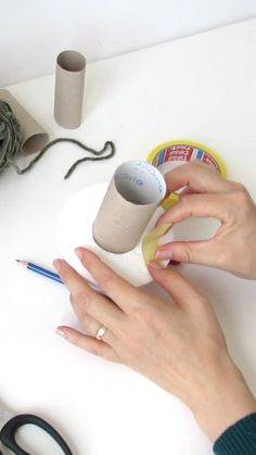 a woman's hands on a table with some crafting supplies