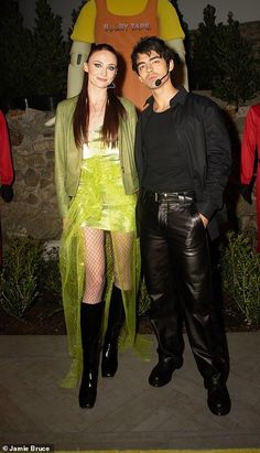 two people standing next to each other in costume