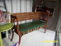 a wooden bench sitting on top of a white rug next to a green table and chair