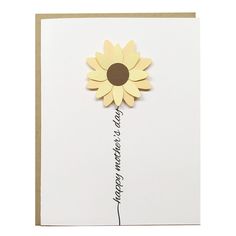 a white card with a yellow flower on it