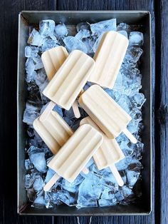 three popsicles sitting on top of ice in a box