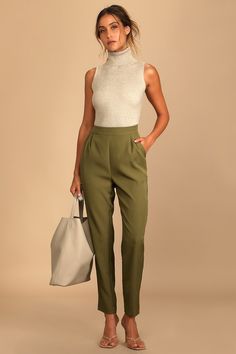 Your workday will go so smoothly with a cup of coffee and the Lulus Like Clockwork Olive Green Trouser Pants! These office-chic pants are composed of woven twill that shapes a high banded waist with two diagonal pockets and pleated accents for a tailored look. Relaxed pants legs end at tapered, ankle-length hems. Hidden side zipper/clasp. Fit: This garment fits true to size. Length: Ankle length. Size medium Inseam: 28.00 Front Rise: 11.50 Waist: Fitted - very fitted at natural waist. Hip: Loose Olive Green Pants Outfit, Olive Green Outfit, Green Pants Outfit, Like Clockwork, Spring School, Relaxed Pants, Olive Pants, Olive Green Pants, Green Trousers