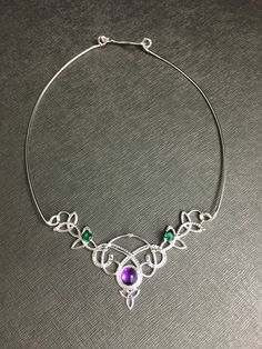 I've fabricated a Celtic Knot statement neck ring, in 925 sterling silver, and I will set your choice of an 8mm cabochon gemstone within the drop down menu. For perspective, I've shown this with amethyst, but you can choose from a varied selection if you prefer. I've made the choker approximately 14.5-15 inches but please specify if you need it longer or shorter as I will accommodate. Also, included will be two, 5mm emerald faceted gems to compliment the piece. If you prefer another color, pleas Sterling Silver Jewelry With Unique Variations For Gifting, Formal Sterling Silver Wire Wrapped Jewelry, Unique Sterling Silver Jewelry As Gift, Handmade Adjustable Silver Custom Necklace, Handmade Sterling Silver Necklace For Wedding, Sterling Silver Soldered Jewelry For Weddings, Unique Sterling Silver Necklaces With Jewels, Unique Wire Wrapped Sterling Silver Jewelry, Unique Sterling Silver Necklace With Jewels