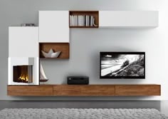 a flat screen tv sitting on top of a wooden shelf