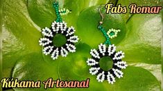 the earrings are made with beads and beadings on green leafy leaves,