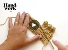 a woman is holding a crochet piece and knitting it with her thumbnails