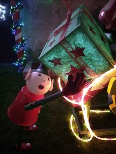 an animated character pulling a christmas sleigh with lights on it's sides