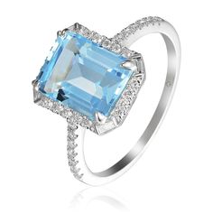 This ring features an emerald-cut blue topaz center surrounded by round brilliant diamonds and a baguette-cut diamond set on each corner with pavé round brilliant diamond side accents in 14K white gold. Total blue topaz weight: 3.54 ct Total diamond weight: 0.23 ct Ring size: 6.5 Circle Monogram, Baguette Cut Diamond, 14k White Gold Ring, Diamond Set, Baguette Cut, White Gold Ring, Brilliant Diamond, Hand Engraving, White Gold Rings