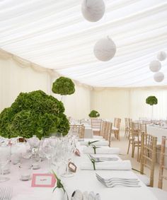 the tables are set with white linens and place settings