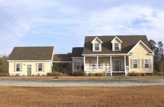 a yellow house with the words mother - in - law suite on it's front