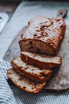 sliced loaf of bread sitting on top of a cutting board