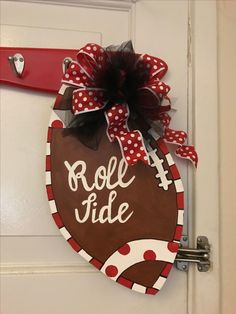 a door hanger that says roll tide with a football on it and polka dots