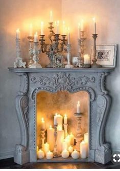 an ornate fireplace with candles lit in it