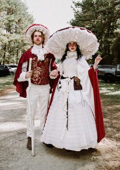 two people dressed in period costumes standing next to each other