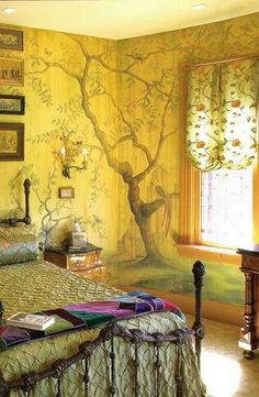 a bedroom with a tree painted on the wall