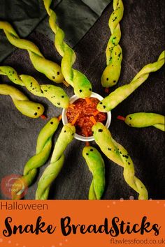 some strange looking food items in a bowl on a black tablecloth with green stems