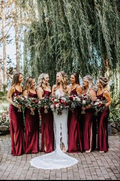 a bride and her bridal party in burgundy dresses