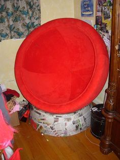 a large red object sitting on top of a wooden floor