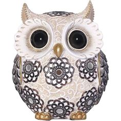 an owl figurine with large eyes and gold accents