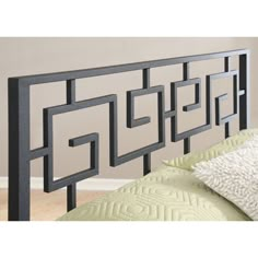 a black headboard with an intricate design on it