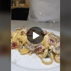 a white plate topped with pasta covered in sauce