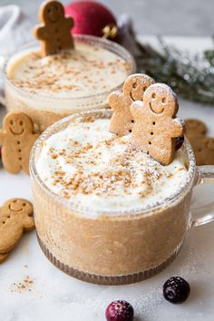 two mugs filled with hot chocolate and topped with ginger cookies