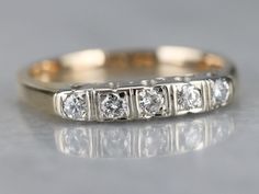 "This pretty band features bright white prongs and a scalloped edge that extends ever so slightly beyond the diamonds. Secure on the finger, this will look well with a variety of engagement rings. The combination of yellow and white gold provides versatility and ensures this piece will match up well with an engagement ring of any metal! Metal: 14K Yellow and White Gold Gem: 5 Diamonds totaling .30 Carats, H in Color, SI1 in Clarity Width of Band: 3.3 mm Height off Finger: 3.4 mm Ring Size: 7.25 Stacking Bands, Cameo Ring, Diamond Glitter, Diamond Wedding Ring, White Gold Band, Blue Jewelry, Diamond Band, Gold Band, Scalloped Edge