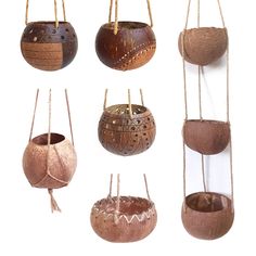 several hanging baskets made out of coconuts and other things that have been carved into them