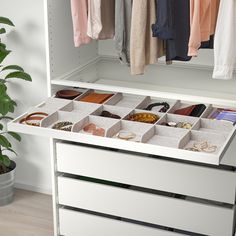 a white dresser with drawers filled with jewelry