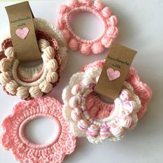 three crocheted scrunffles with tags attached to them