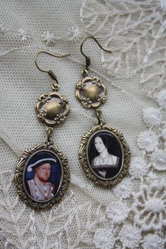 a pair of earrings with an image of a woman