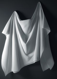 a white draped object on a black background