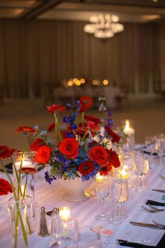 the table is set with red, white and blue flowers