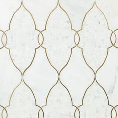 a white marble tile with gold lines and circles in the middle, on top of it