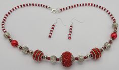 The 19 inch necklace is made with red sparkly round beads, red seed beads, round silver spacer beads and clear seed beads.  Necklace has a sterling silver lobster clasp and jump ring for closure.  Matching earrings are made with the red and clear seed beads.  Earrings have a sterling silver earring wire and hang a total of 1 1/2 inches in length. Seed Beads Earrings, Seed Beads Necklace, Silver Statement Necklace, Earring Wire, Silver Necklace Statement, Beads Earrings, Necklace And Earring Set, Beads Necklace, Jump Rings