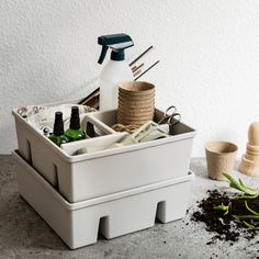 a white container filled with lots of bottles and other items on top of a table