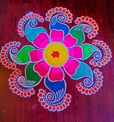 a colorful flower design on a wooden table