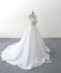 a white wedding dress on a mannequin in front of a white wall with the words lace bridal