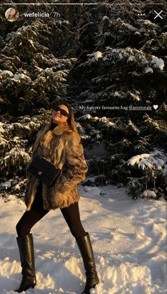 a woman walking in the snow wearing boots and a fur coat with her hand on her hip