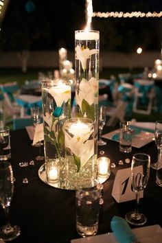 the centerpieces are decorated with flowers and candles